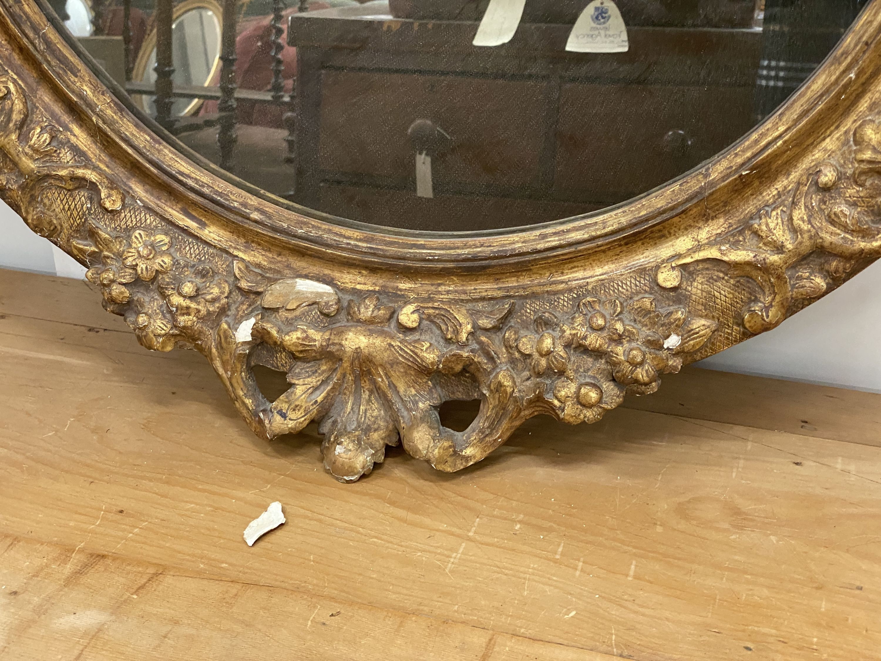 An oval giltwood and gesso wall mirror, width 89cm, height 108cm